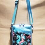 Small crossbody blue bag with a mermaid design on it