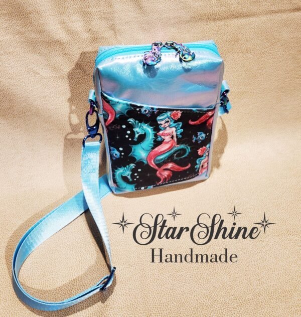 Small crossbody blue bag with a mermaid design on it