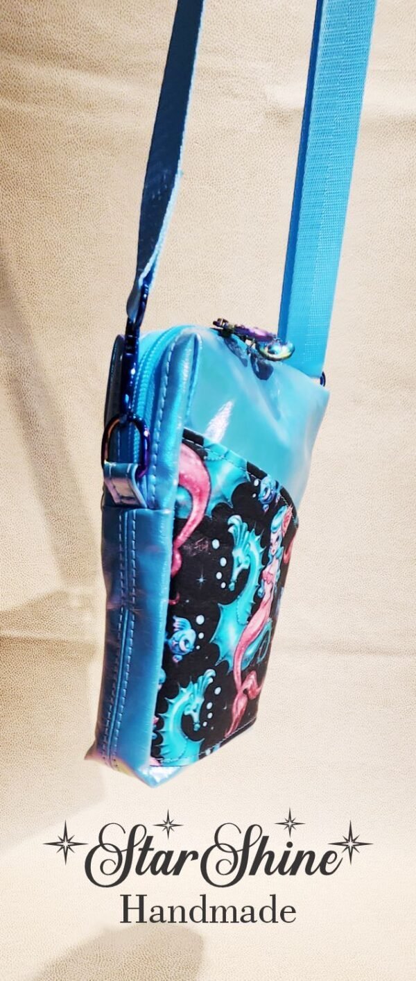 Small crossbody blue bag with a mermaid design on it